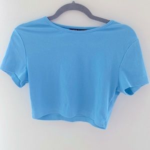 Light blue cropped shirt.